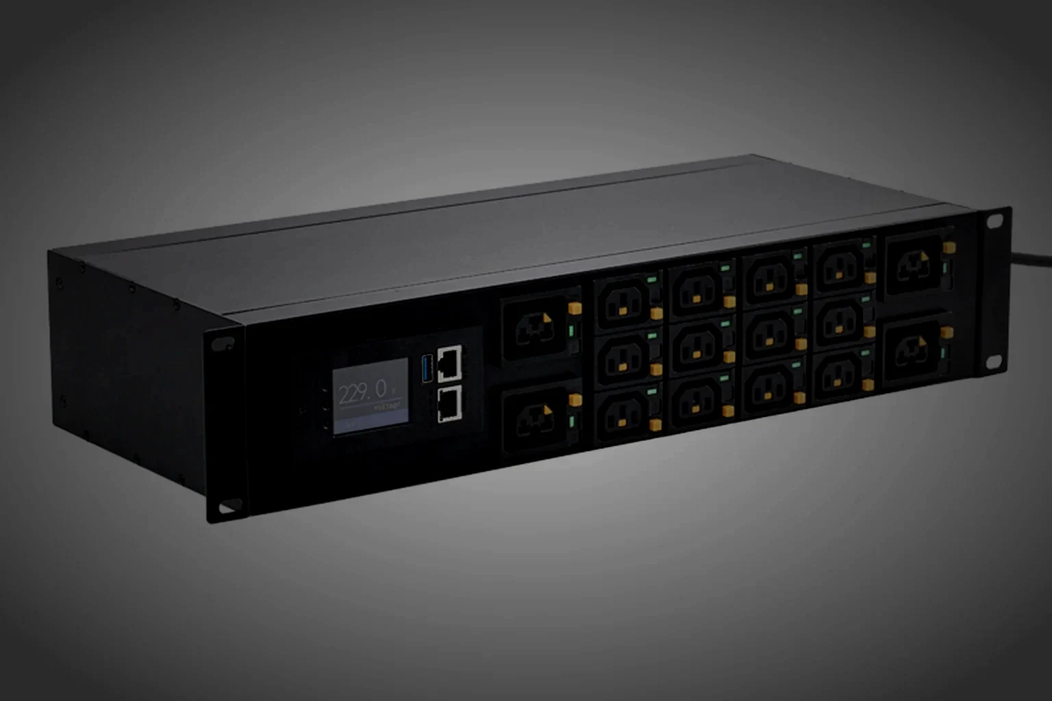 A completed rack PDU mounted in an open equipment cabinet, its chassis depth and outlet row reading as one continuous line under a single raking light